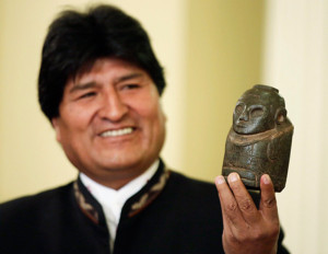 Bolivia's President Evo Morales holds a fertility statue as he speaks during a news conference at the presidential palace in La Paz